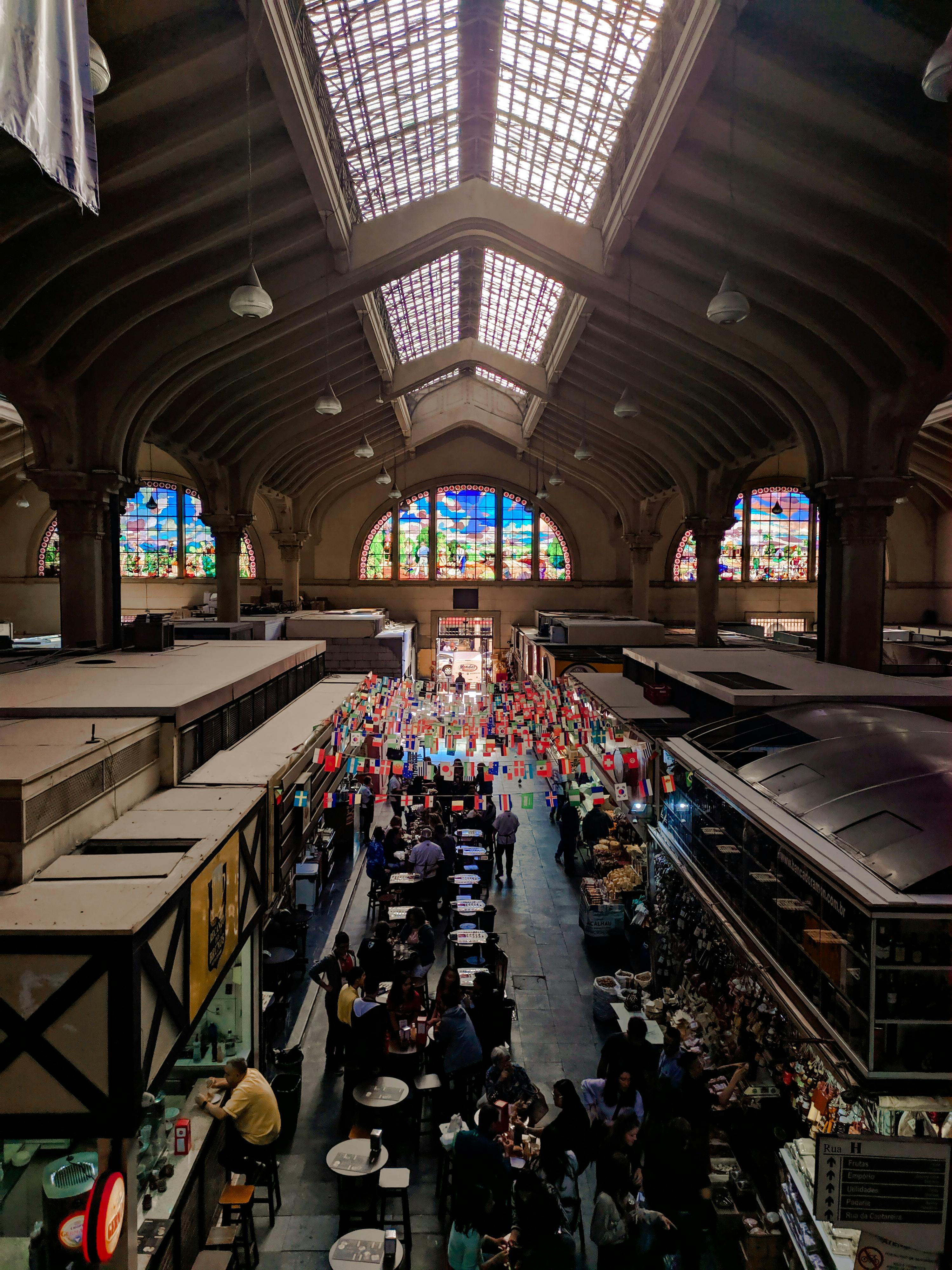 Food hall with different stalls and people ordering food