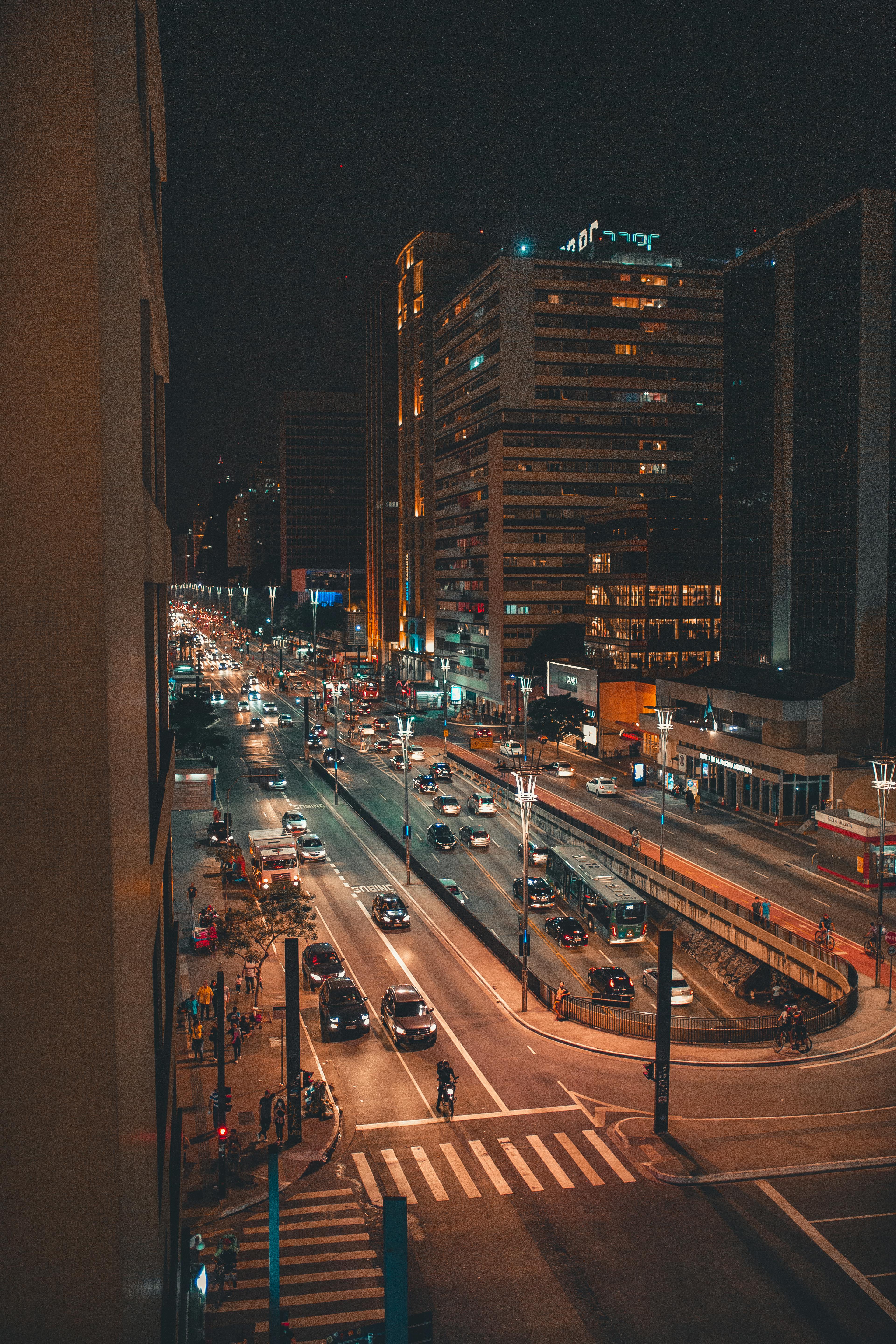 Avenida Paulista at night with tall buildings and bright lights